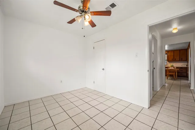 a view of backyard of house with a slide and a table