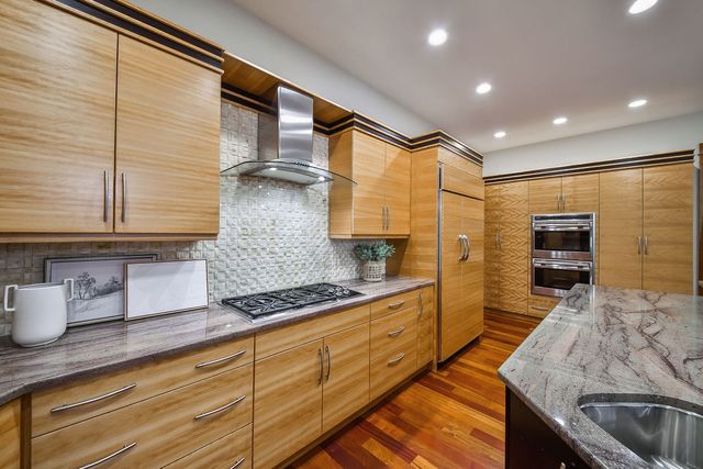 a living room with furniture a flat screen tv and a window