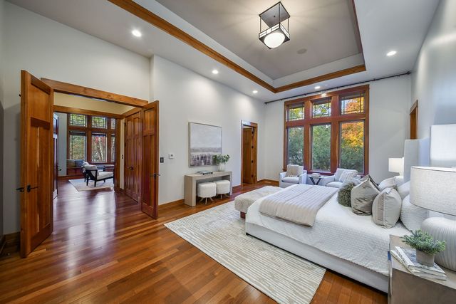 a bathroom with a tub a sink and a large mirror