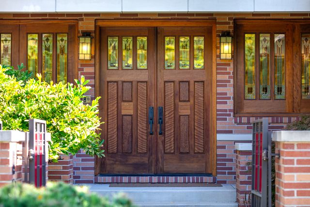 a view of a brick house with large windows