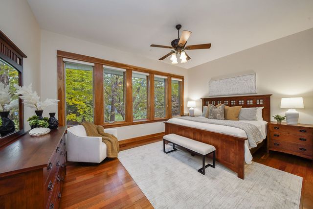 a bedroom with a bed and a large window