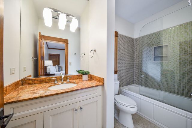a bathroom with a shower and a sink