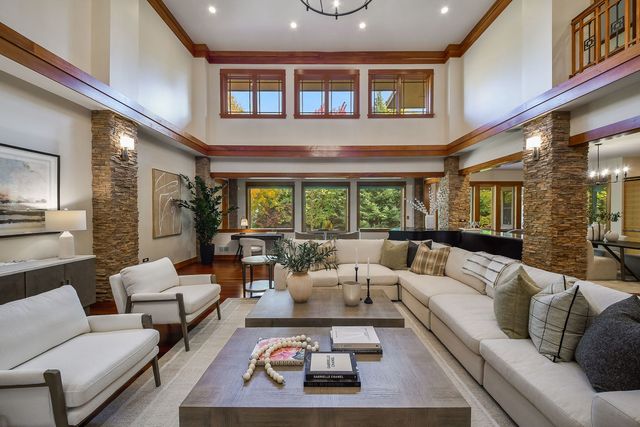 a living room with furniture a fireplace and a large window