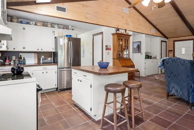 a kitchen with stainless steel appliances granite countertop a sink and a refrigerator
