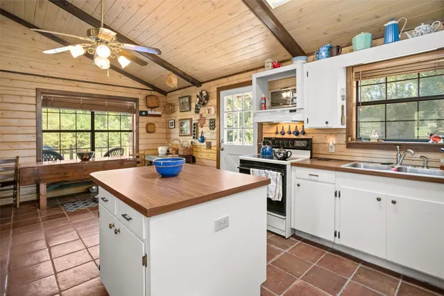 a kitchen with stainless steel appliances granite countertop a sink and a stove