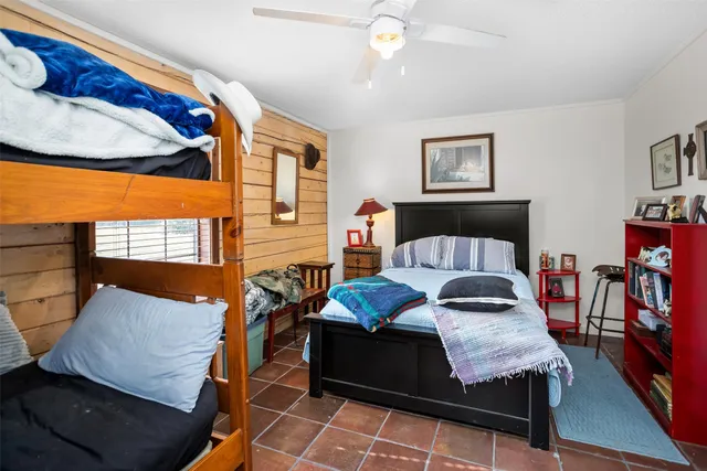 a bedroom with furniture and wooden floor