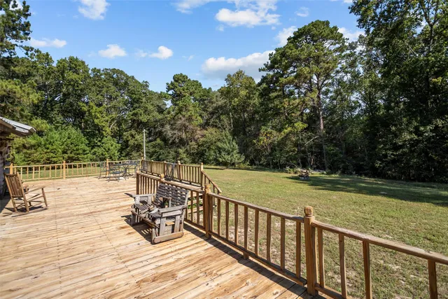 a view of outdoor space with deck and yard