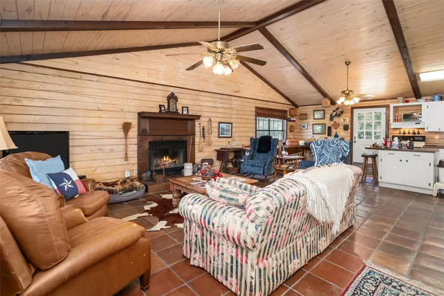 a living room with furniture a fireplace and white walls