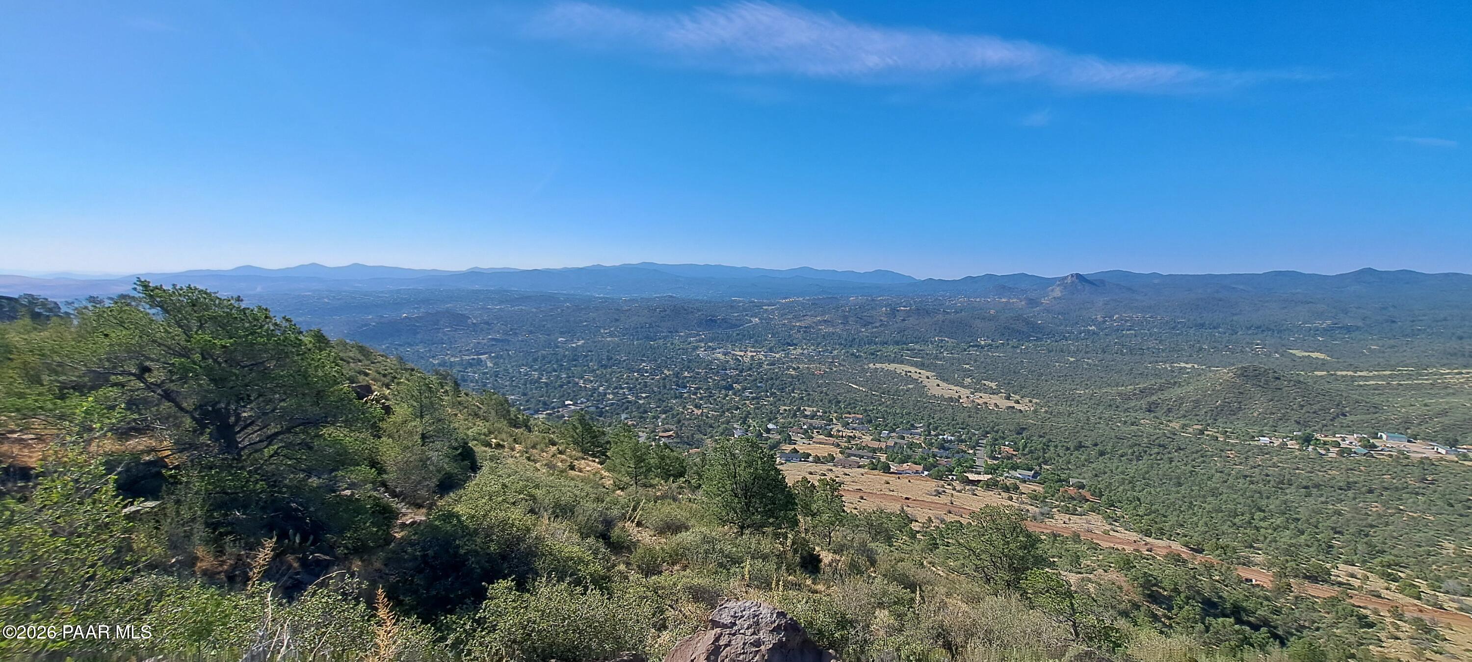a view of a large mountain with mountains in the background