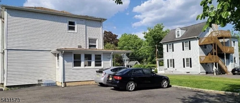 358 Woodland Road, Unit 2 Madison, NJ 07940 - Photo 44 of 50 a car parked in front of a white house
