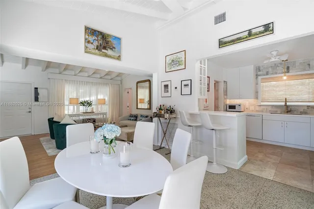 a living room with furniture a dining table and chairs