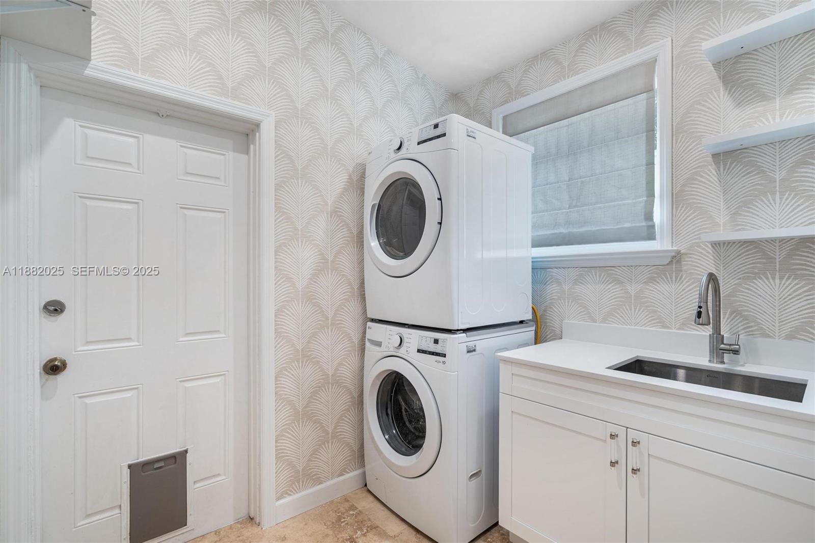 9357 Northeast 9th Place Miami Shores, FL 33138 - Photo 16 of 51 a utility room with sink dryer and washer