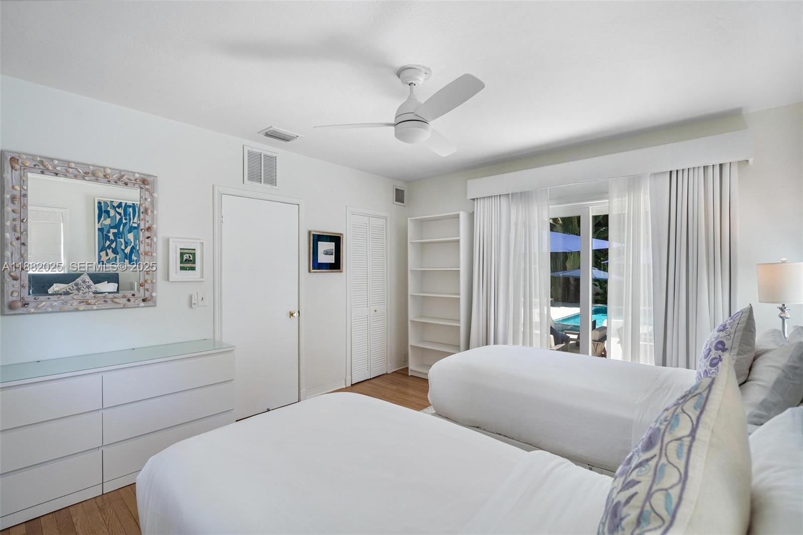 9357 Northeast 9th Place Miami Shores, FL 33138 - Photo 23 of 51 a bedroom with a large bed and a window