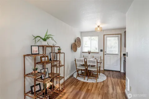 a view of a dining room with furniture and wooden floor
