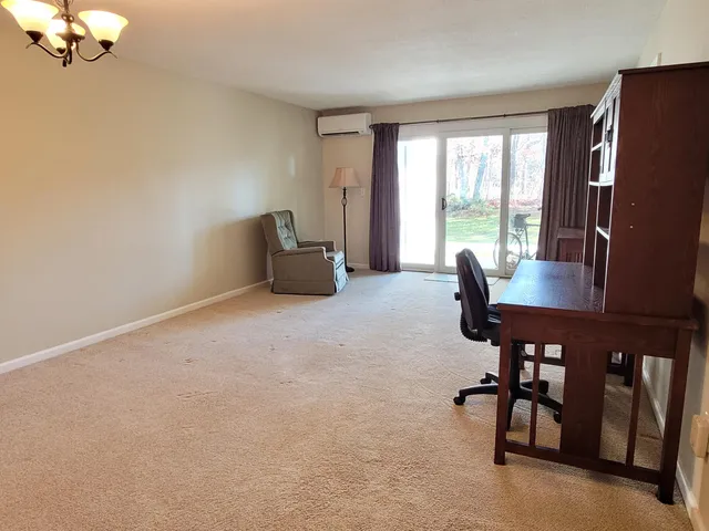a view of a livingroom with furniture and a window