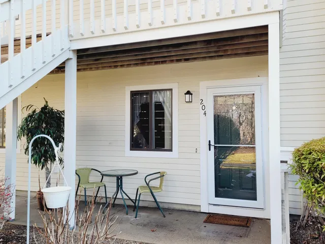 a view of a two chairs and table in the balcony