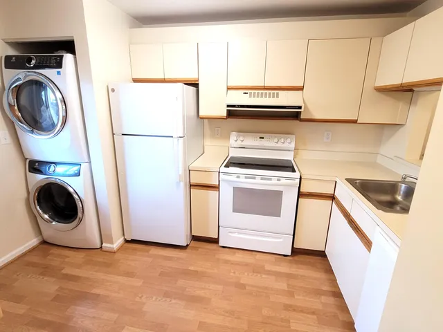 a kitchen with a stove top oven and cabinets