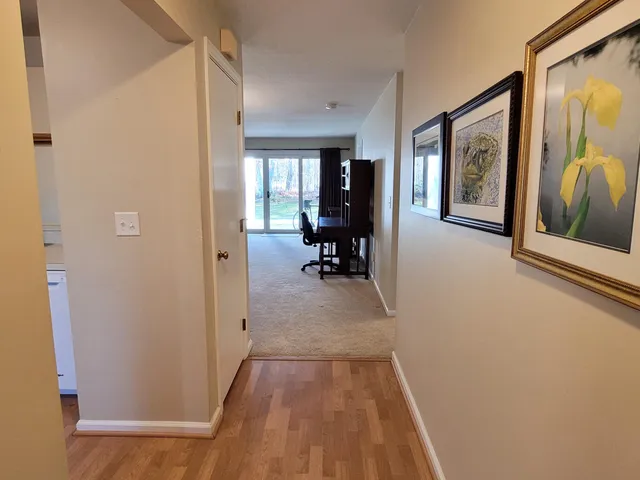 a view of a hallway with furniture and windows