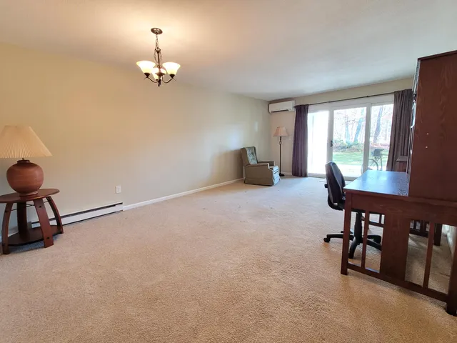 a view of a livingroom with furniture and a window