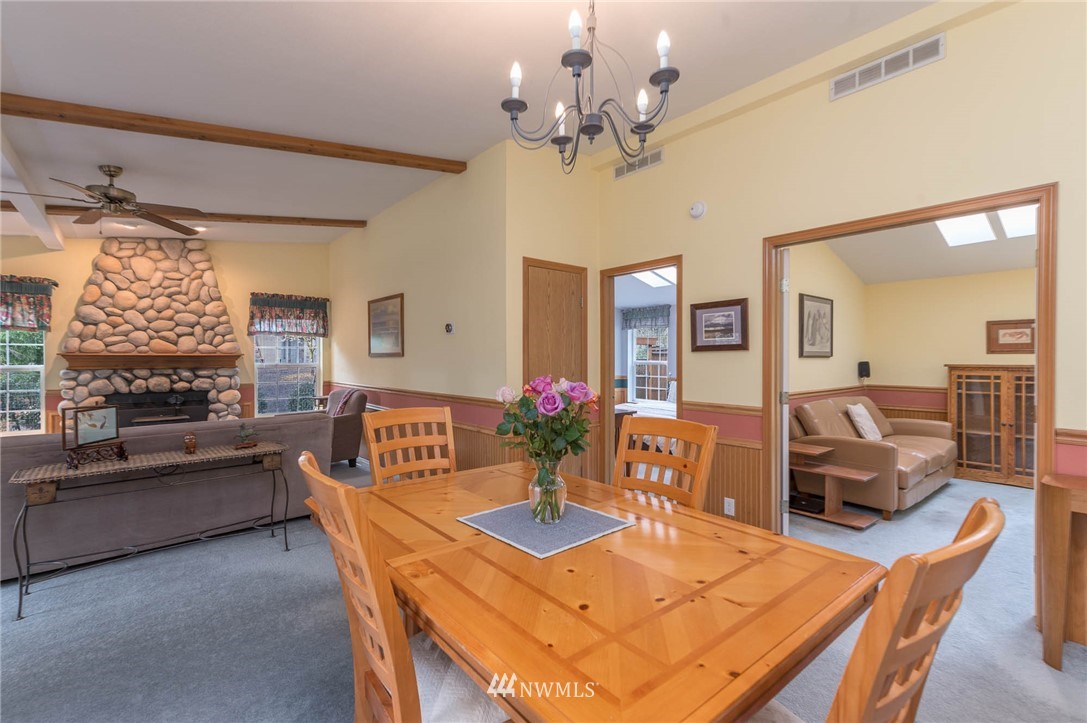18109 Thorsen Road Southwest Vashon, WA 98070 - Photo 12 of 37 a view of a dining room with furniture window and wooden floor