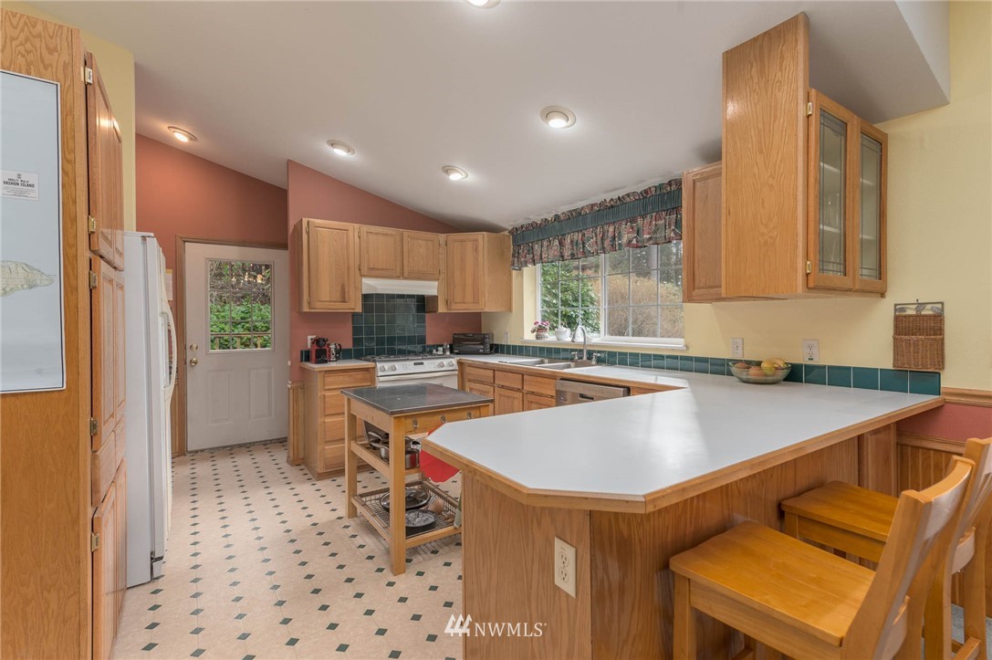 18109 Thorsen Road Southwest Vashon, WA 98070 - Photo 16 of 37 a kitchen with a sink a counter top space and stainless steel appliances