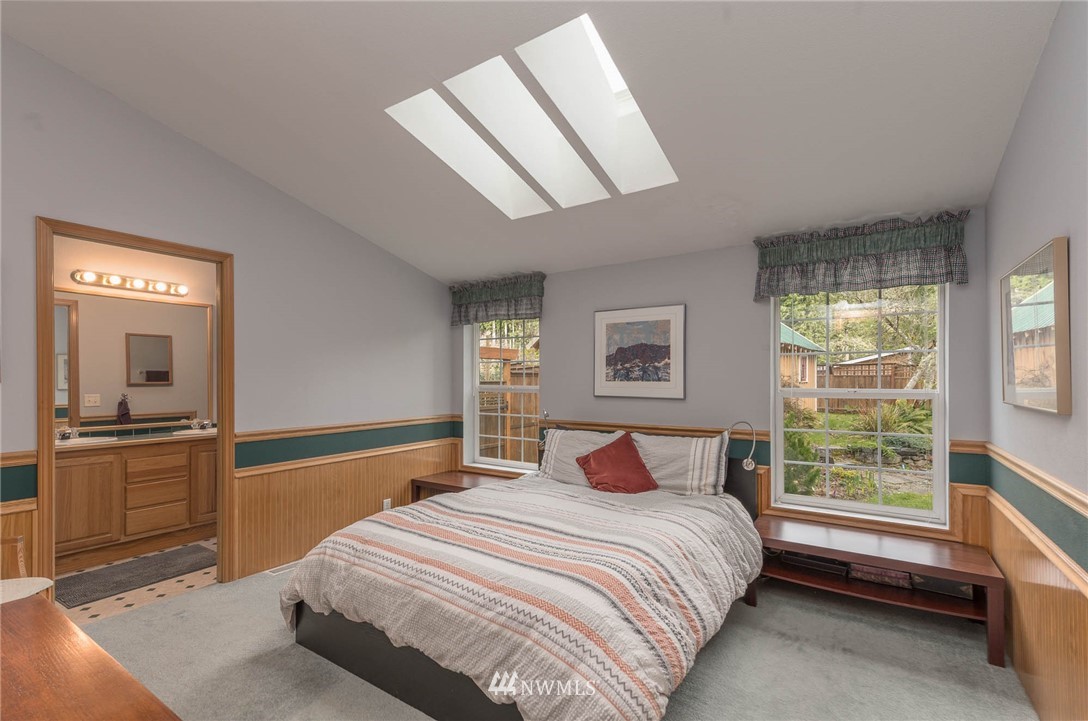 18109 Thorsen Road Southwest Vashon, WA 98070 - Photo 17 of 37 a bedroom with a large bed and a window