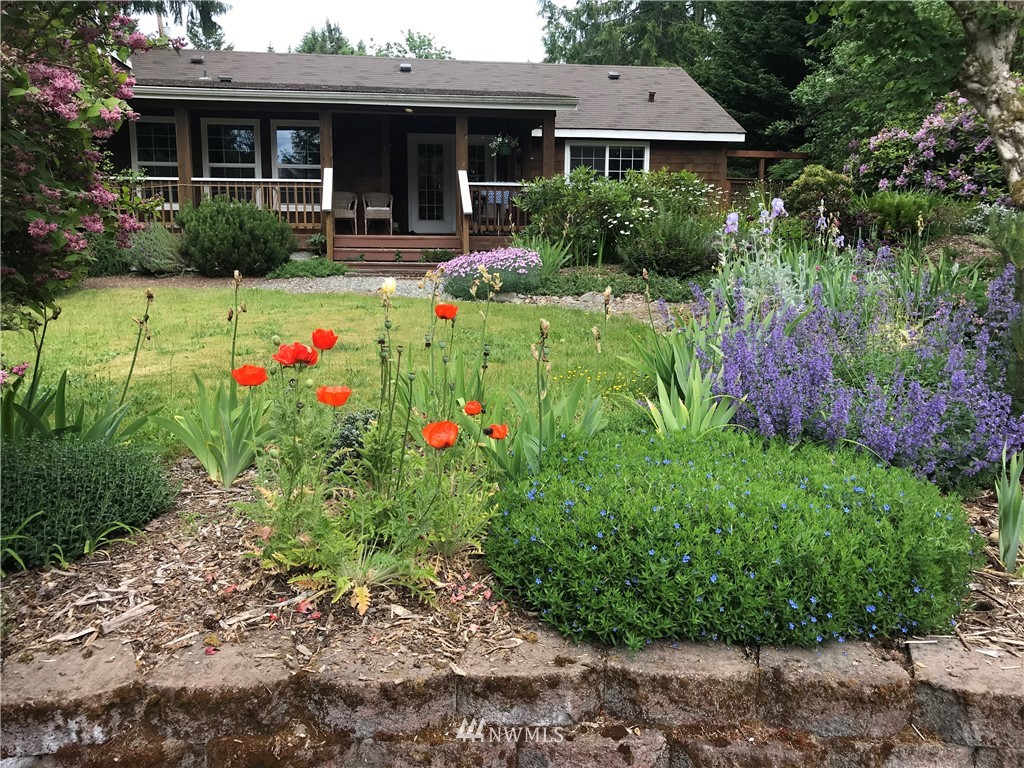 18109 Thorsen Road Southwest Vashon, WA 98070 - Photo 33 of 37 a view of a house with a big yard and potted plants