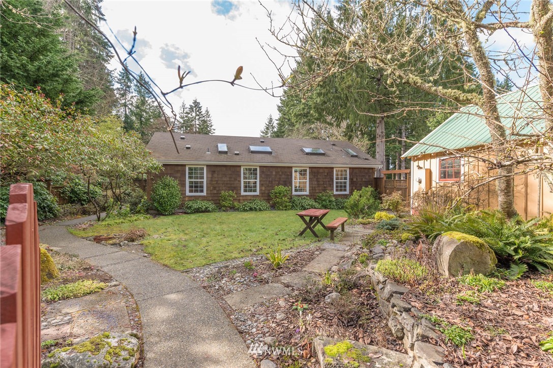 18109 Thorsen Road Southwest Vashon, WA 98070 - Photo 5 of 37 a front view of a house with a yard and porch