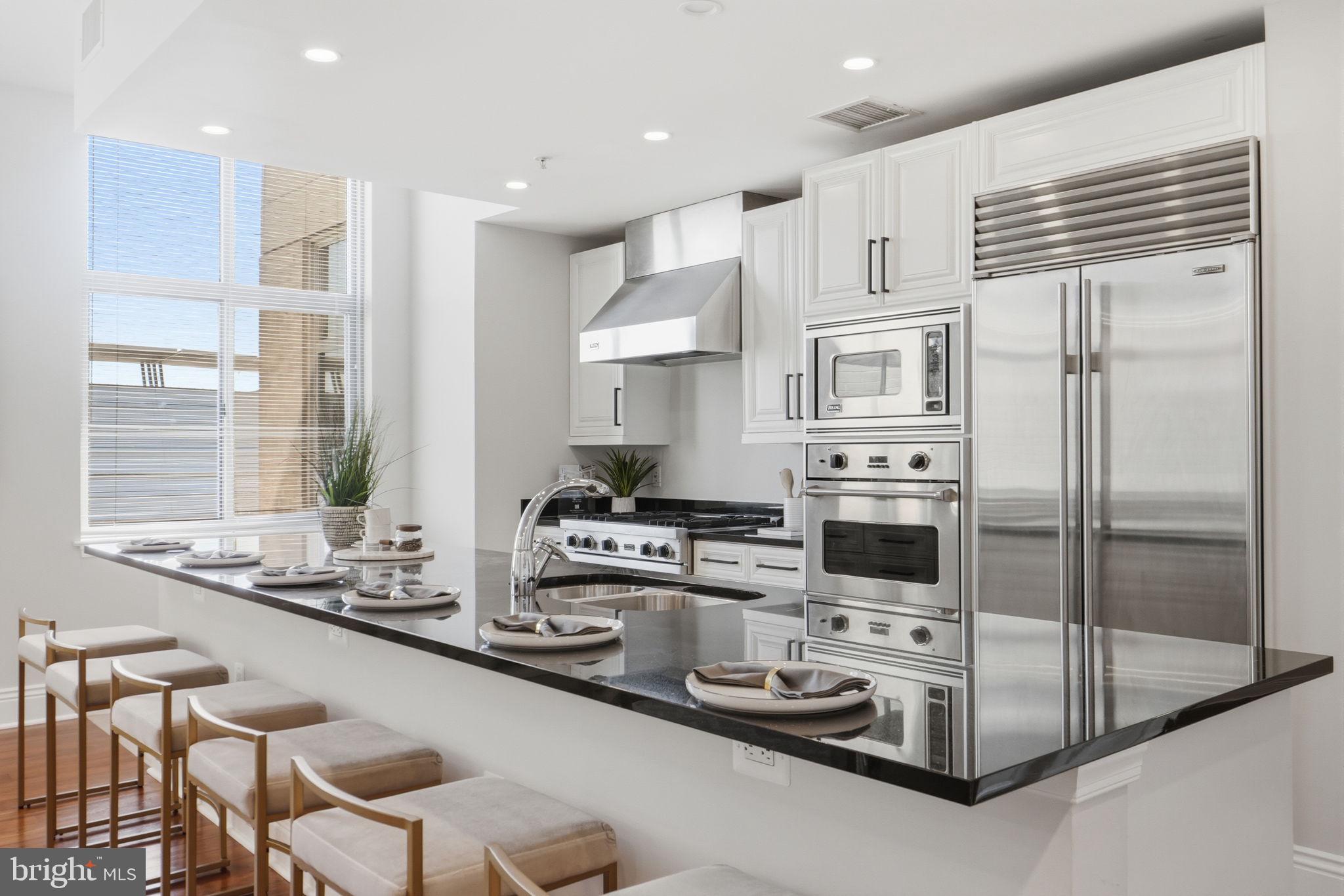 11990 Market Street, Unit 2103 Reston, VA 20190 - Photo 14 of 78 Sleek modern kitchen with bright ambiance.