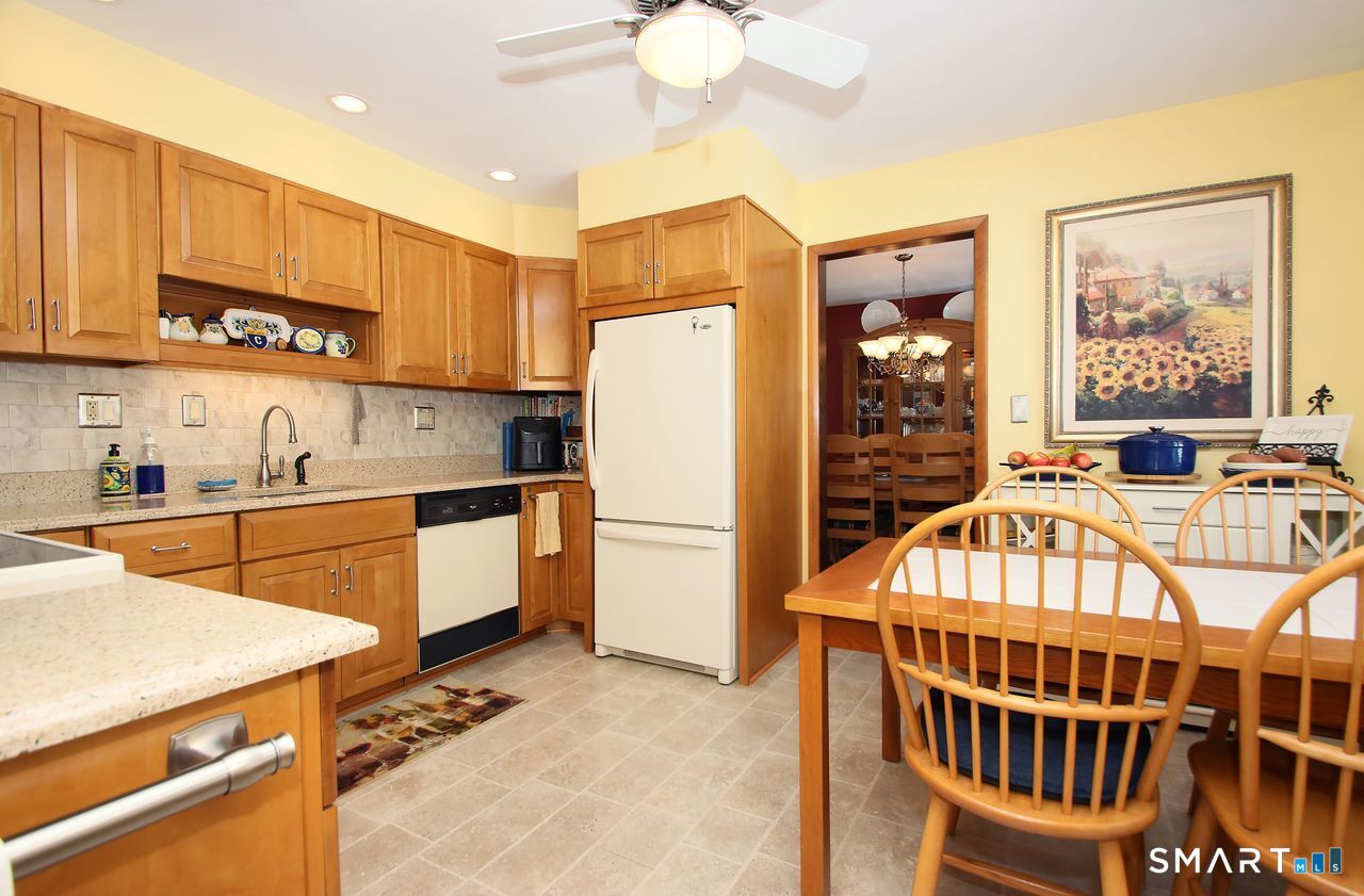 7 Old Forge Road North Haven, CT 06473 - Photo 17 of 40 a kitchen with stainless steel appliances a refrigerator a stove a sink cabinets and a dining table