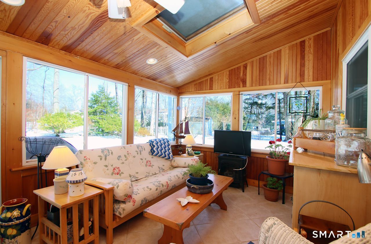 7 Old Forge Road North Haven, CT 06473 - Photo 23 of 40 a living room with furniture a fireplace and a large window