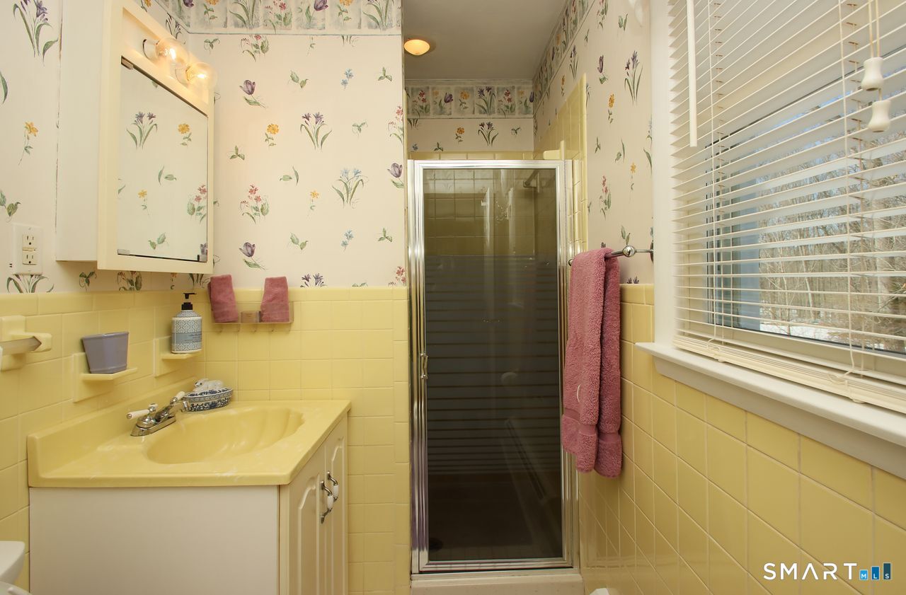 7 Old Forge Road North Haven, CT 06473 - Photo 25 of 40 a bathroom with a sink a mirror and shower