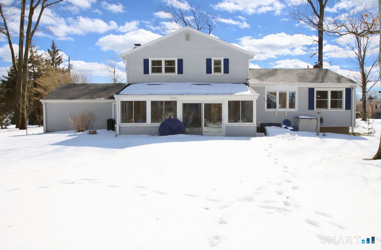 7 Old Forge Road North Haven, CT 06473 - Photo 4 of 40 a front view of a house with a yard covered with snow