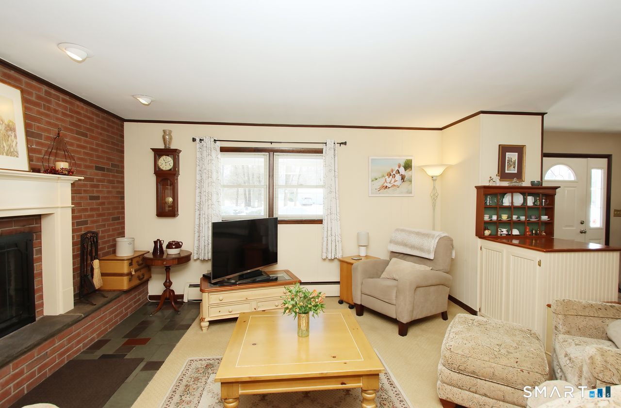 7 Old Forge Road North Haven, CT 06473 - Photo 9 of 40 a living room with furniture and a flat screen tv