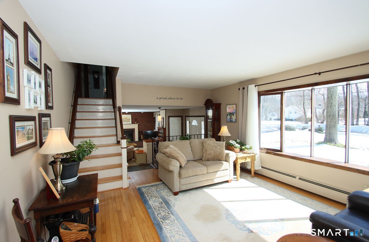 7 Old Forge Road North Haven, CT 06473 - Photo 10 of 40 a living room with furniture fireplace and a large window