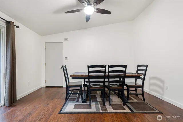a view of a dining room with furniture and wooden floor