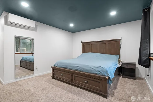 a spacious bedroom with a bed and a view of balcony