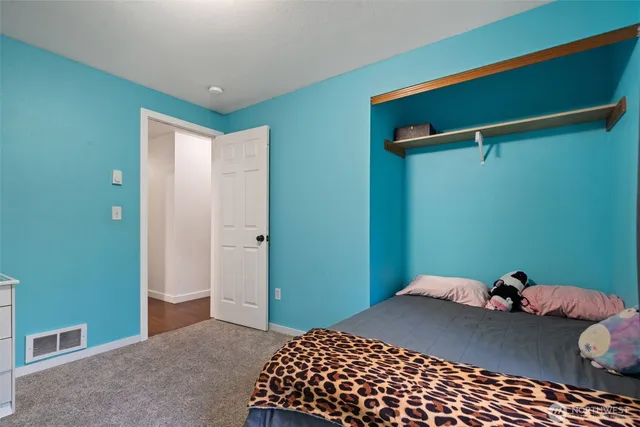 a bedroom with a bed and a dresser