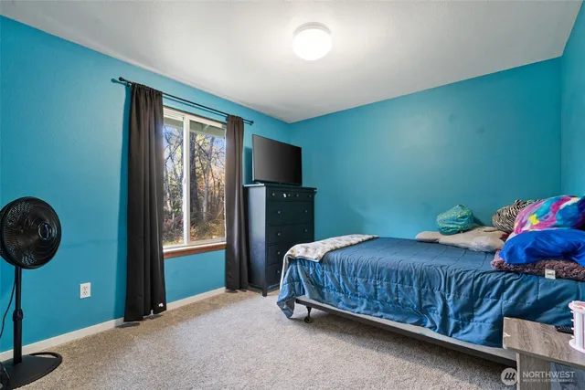 a bedroom with a bed and window