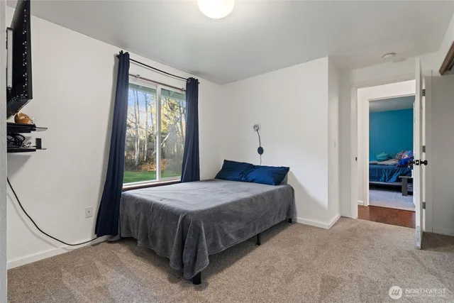 a bedroom with a bed and a mirror