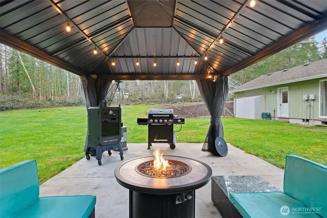 a view of a patio with a table chairs and a backyard