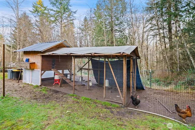 a view of a wooden chairs and table in the back yard