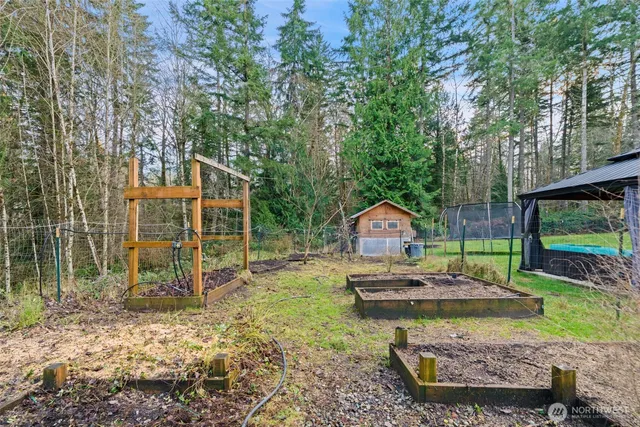 a backyard of a house with table and chairs