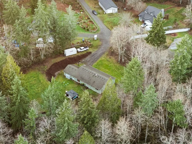 an aerial view of a house with a yard
