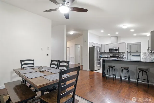 a view of a dining room with furniture and wooden floor