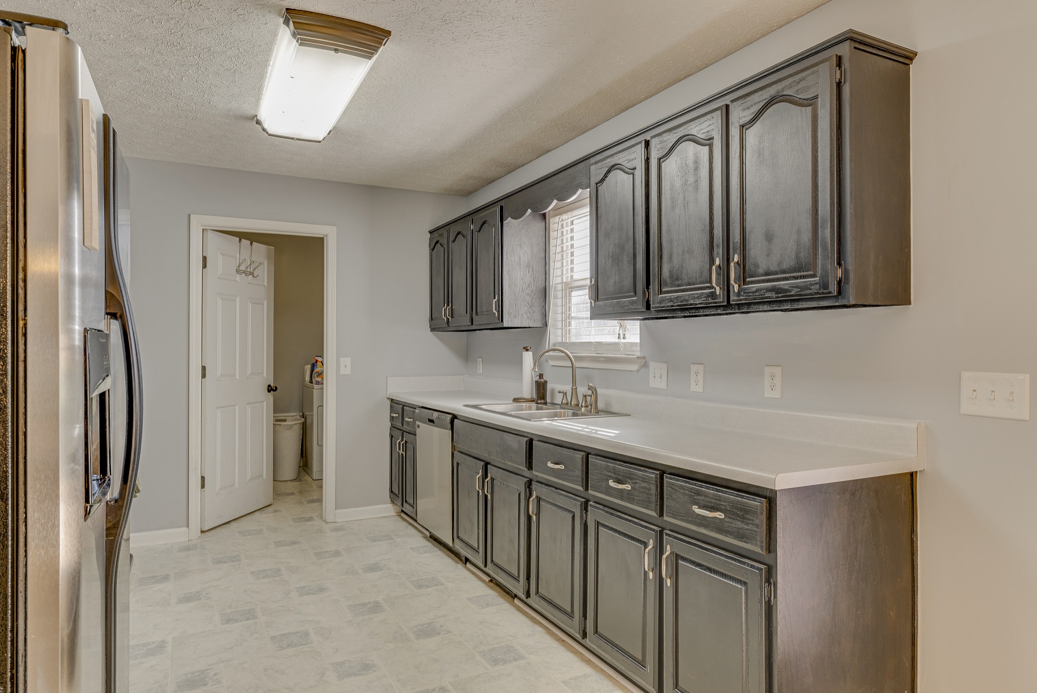 140 Cora Street Portland, TN 37148 - Photo 11 of 27 a kitchen with stainless steel appliances granite countertop a refrigerator and a sink