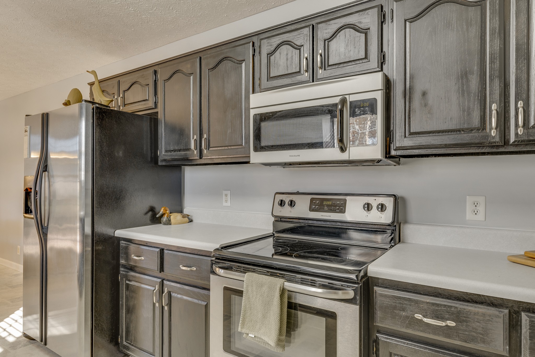 140 Cora Street Portland, TN 37148 - Photo 12 of 27 a kitchen with stainless steel appliances granite countertop a refrigerator stove and cabinets