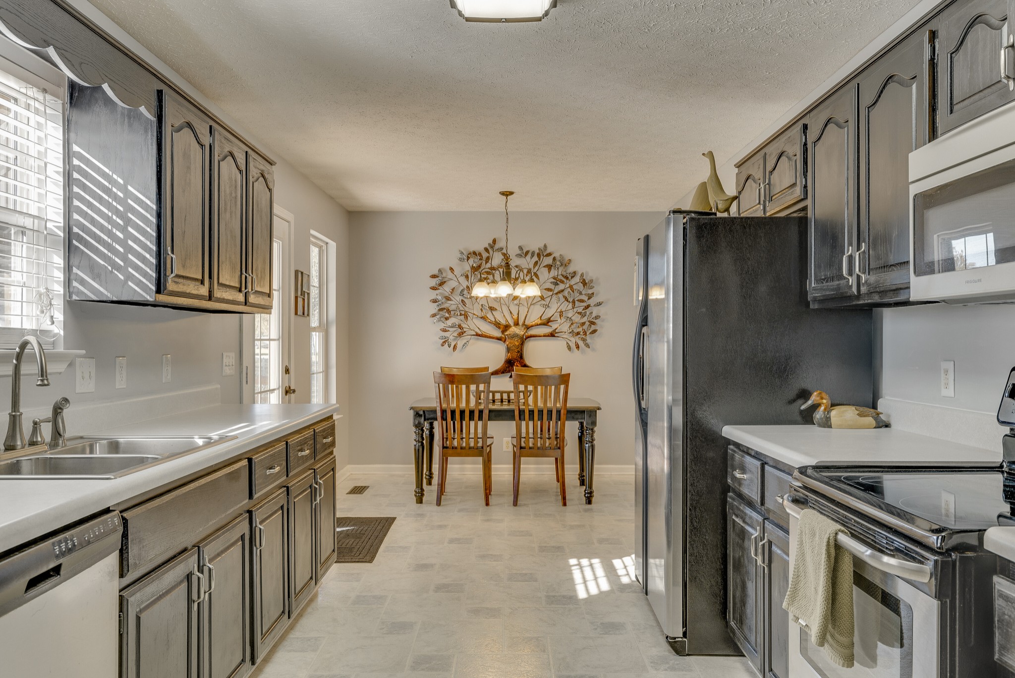 140 Cora Street Portland, TN 37148 - Photo 13 of 27 a kitchen with stainless steel appliances granite countertop a sink stove and refrigerator