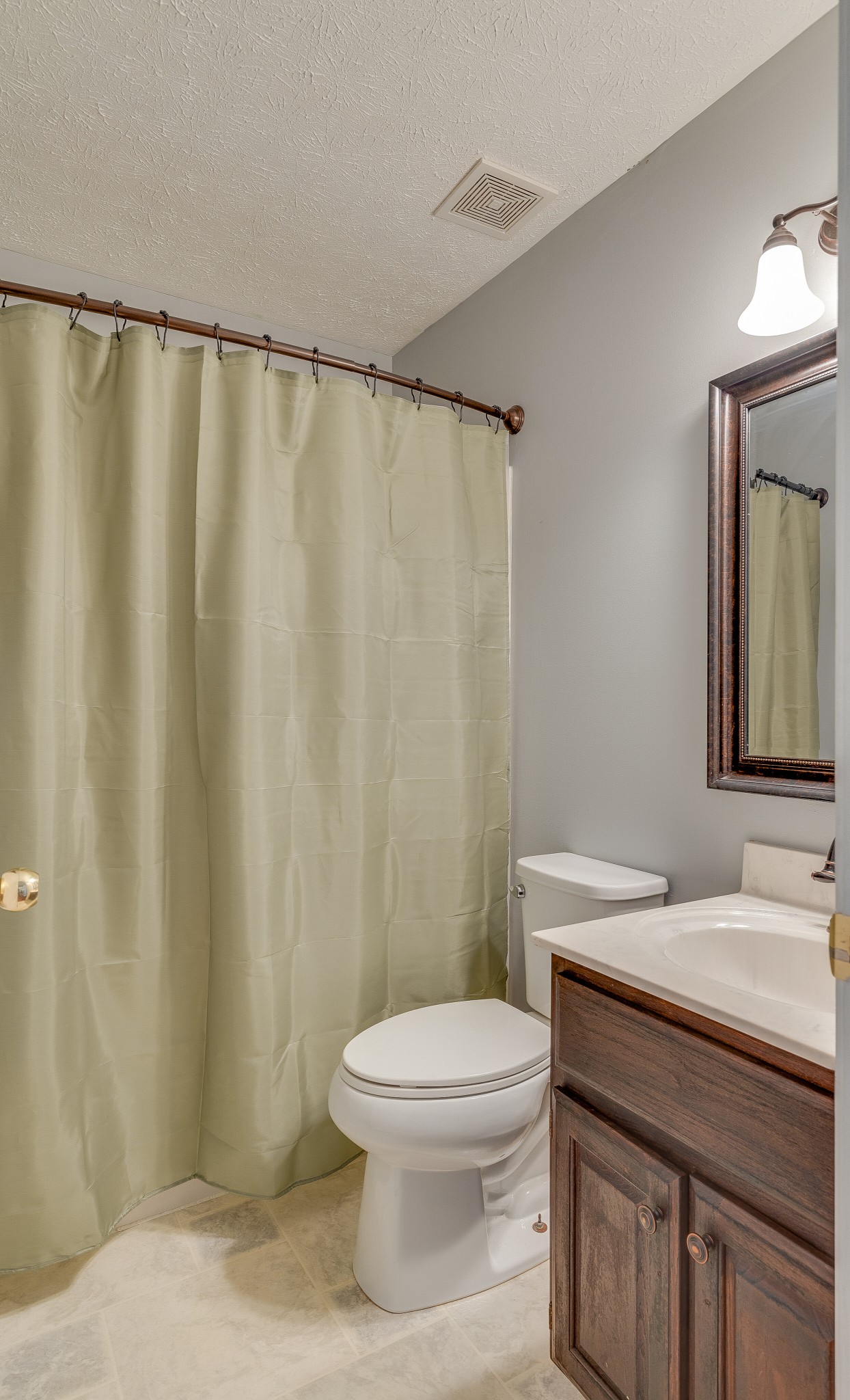 140 Cora Street Portland, TN 37148 - Photo 19 of 27 a bathroom with a sink a toilet and shower curtain
