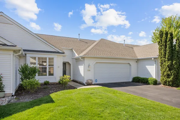 a front view of house with yard and outdoor seating